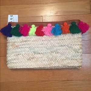 Woven clutch bag with rainbow yarn tassels